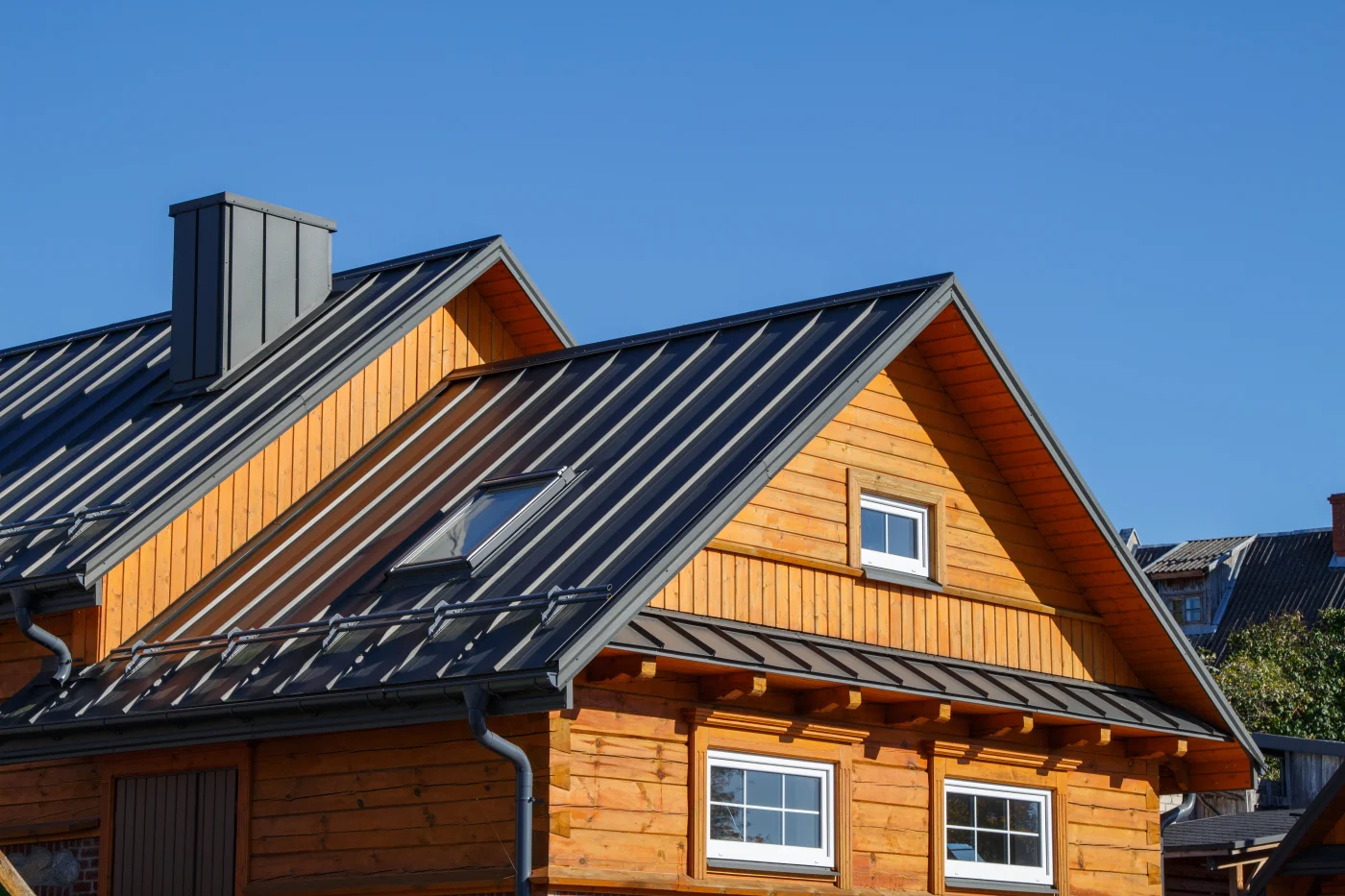 A metal roof on a brown log home.