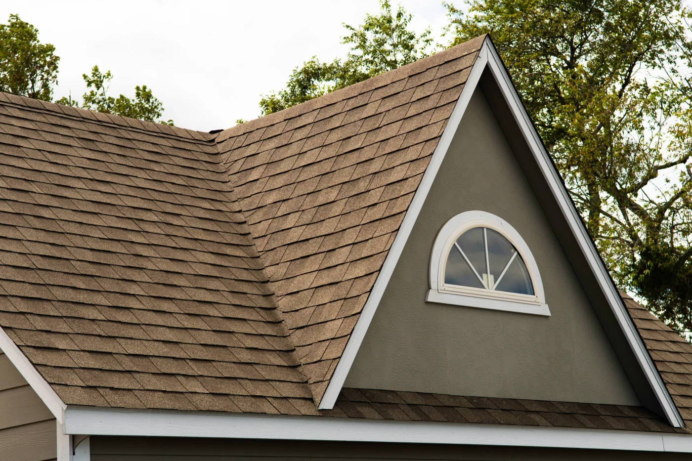 A home with a brown shingle roof.