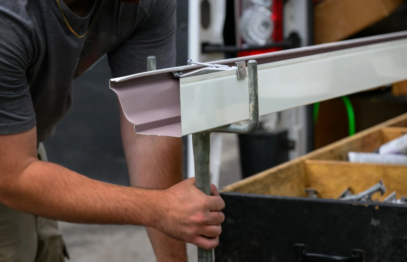 Seamless gutters being cut on-site for installation.