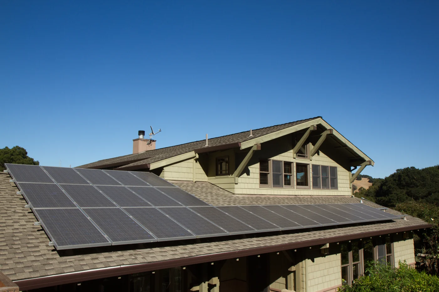 A home with solar panels installed on the shingle roof.