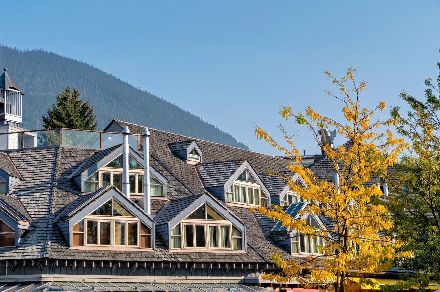 A beautiful multi-level home in Thornton, CO with multiple gable windows and gray shingle roofing.